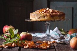 Apple cake with dried apple rings on a cake stand