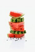 A stack of watermelon slices with seeds