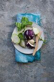 Green and purple kohlrabi on a plate