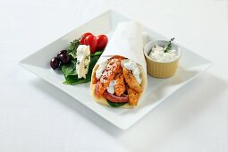 A wrap with smoked fish, crème fraîche and a side salad