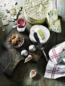 An arrangement of cheese with lingonberry jam, walnuts and figs
