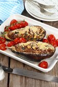 Aubergines filled with minced meat served with oven roasted tomatoes