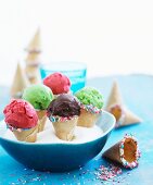 Various sorbets in mini cones with sugar sprinkles