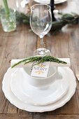 Lion-head bowl on white place setting decorated for Christmas