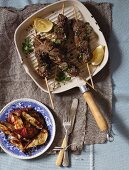 Beef skewers with parsley, lemon and roast sweet potatoes