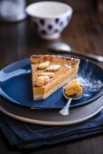 A slice of pumpkin pie on a plate with a spoon