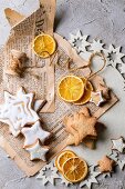 Glazed Christmas star biscuits and dried orange slices on an old newspaper