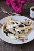 Pancakes with quark and blueberries decorated with lemon balm