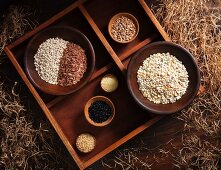 Various types of grains in wooden bowls in a rustic atmosphere
