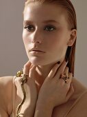 A young woman with damp red hair and bold rings