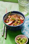 Noodles with beans, peppers, plums and cashew nuts in a soy dressing