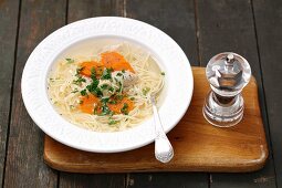 Chicken broth with noodles and carrots