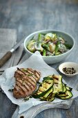 Grilled lamb chop with courgettes and potato salad