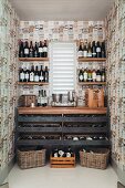 Wine store below and flanking window in custom-built wine racks in narrow room