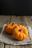 Two pumpkins on linen napkin