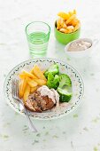 Veal meatballs in Madeira sauce with chips and broccoli