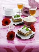 Cream slices with icing sugar and whipped cream
