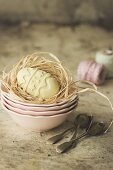 A white chocolate egg in an Easter nest