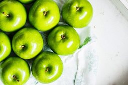 Green apples on a white napkin