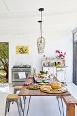 Set wooden table and retro stools in simple kitchen