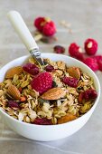Breakfast cereal with almonds and fresh raspberries