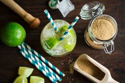A Virgin Caipirinha Cocktail made from ginger ale, limes and brown sugar with straws