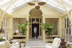 Wicker furniture in Art Nouveau conservatory of classic villa