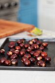 Roasted chestnuts on a baking tray