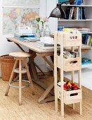 DIY shelves for stationary made from wooden crates, vintage wooden table and stool on sisal rug