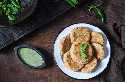 Baked millet and cheese fritters with a herb sauce
