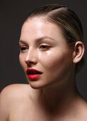 A young woman wearing red eyeliner and red lipstick