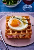 Waffles with fried eggs and ham