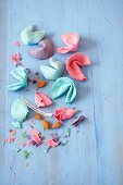 Colourful, homemade fortune cookies, partially crumbled
