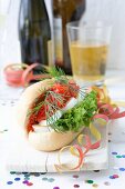 A salmon roll with egg, lettuce and dill, decorated with paper streamers and confetti