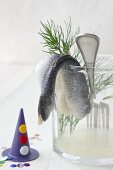 Rollmops on the edge of a glass