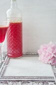 Home-made raspberry in a bottle and a glass