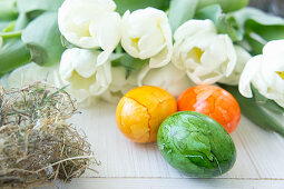 Painted Easter eggs and white tulips