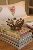 Vintage crown on shabby-chic stack of books