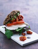 A wholemeal roll with mozzarella, rocket, tomatoes and avocado