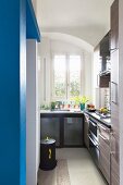 Narrow kitchen with blue wall