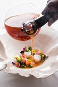 Vegetable and hibiscus tea broth with lobster medallions