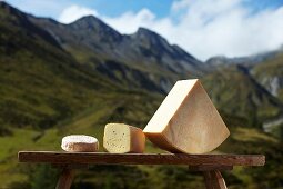 Alpine cheese against a mountain backdrop