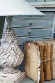 Books tied together with string next to table lamp