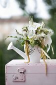 Green and white bouquet with white orchids in watering can
