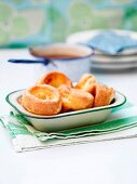 Yorkshire puddings in a ceramic dish on a table