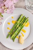 Asparagus with lemon sauce on a garden table