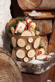 Plant pot full of presents decorated for winter with slices of branches