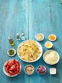 Ingredients for gratinated nachos with a dip