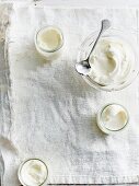 Joghurt in Gläsern und Glasschüssel von oben