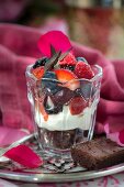 Red Velvet brownies with vanilla cream and fresh fruit in a dessert gloss